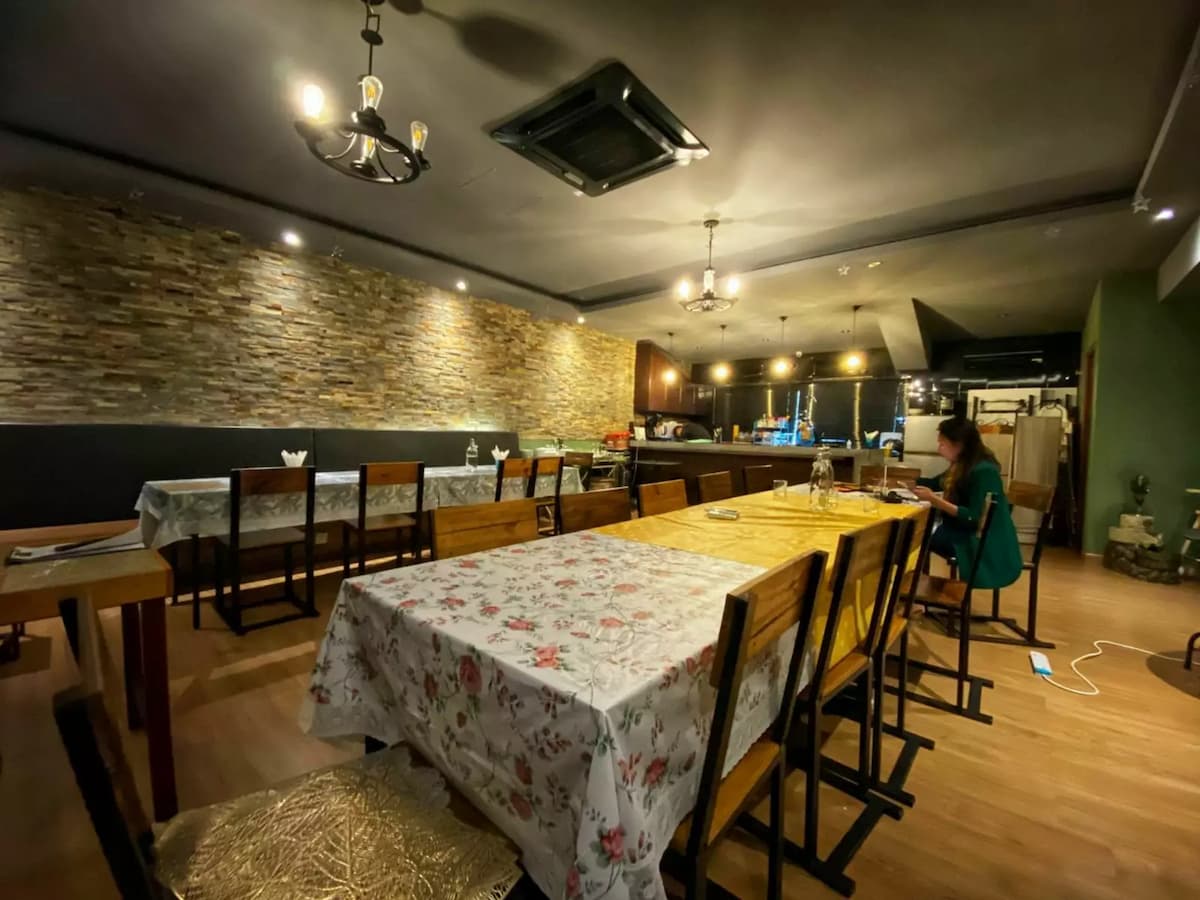 dining area with lady setting up tables