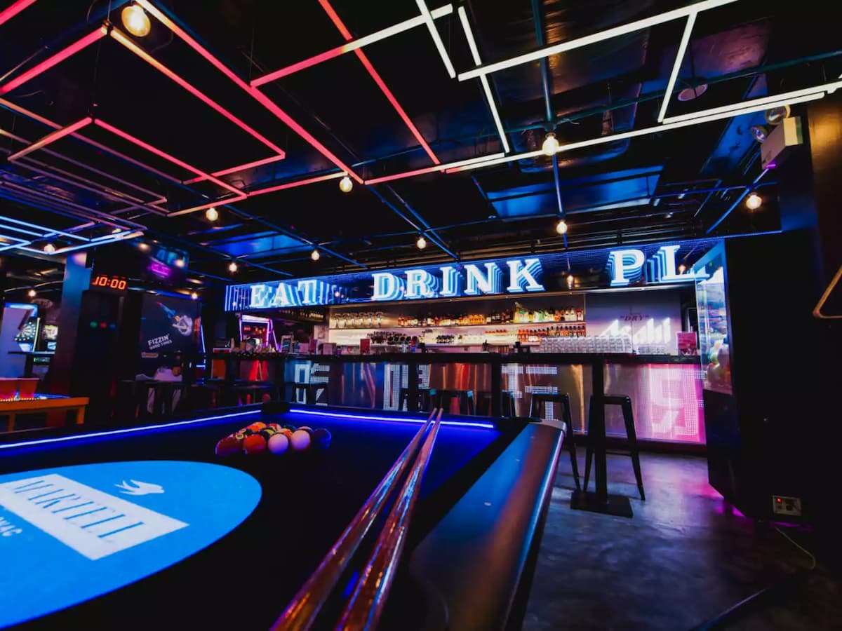 "eat drink play" neon logo in bar area