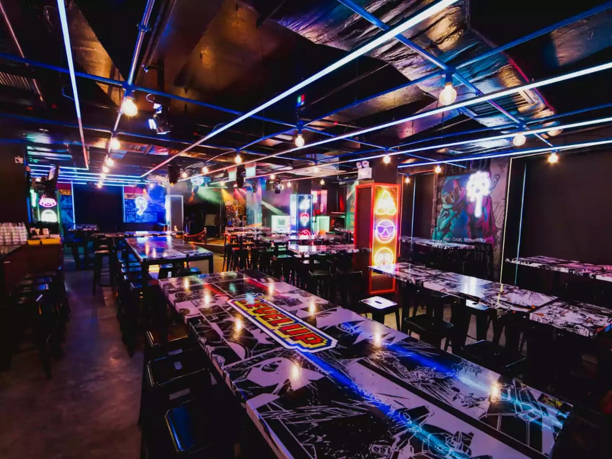 decorated long tables in event space with neon lights