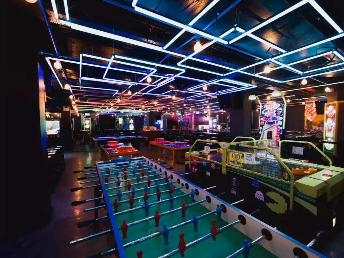 fuse ball table, pacman table, arcade in dining area