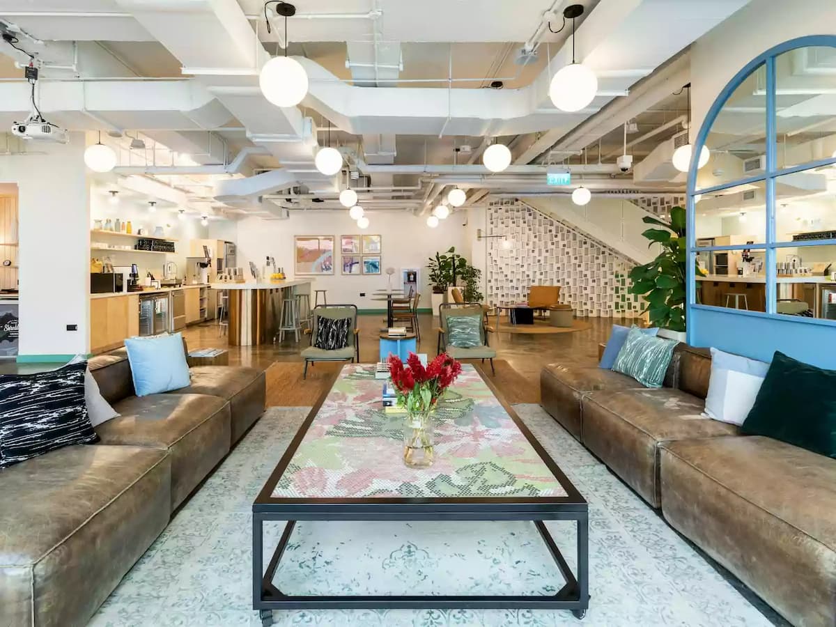 office area with sofa and couch and bulbed lights, quirky decorations