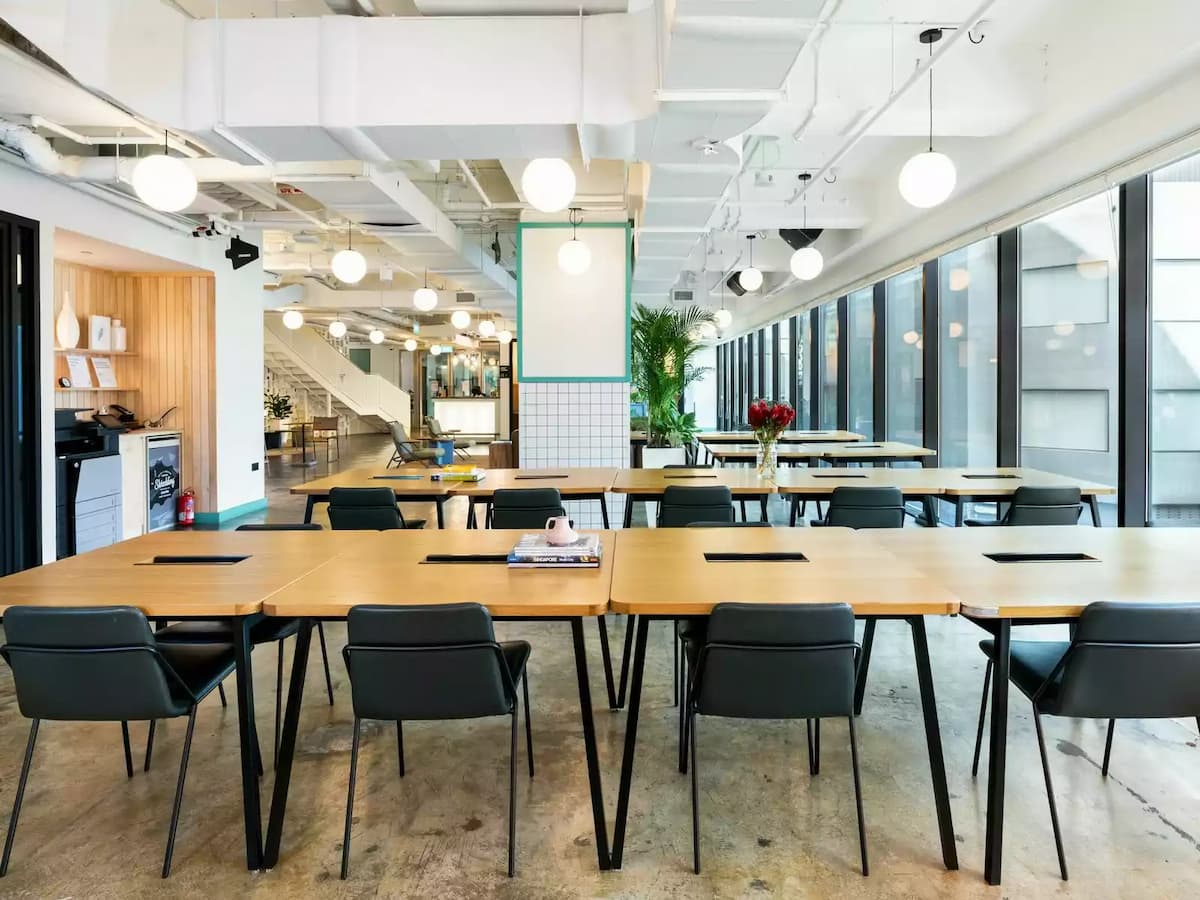 long tables with coworking amenities in industrial style room