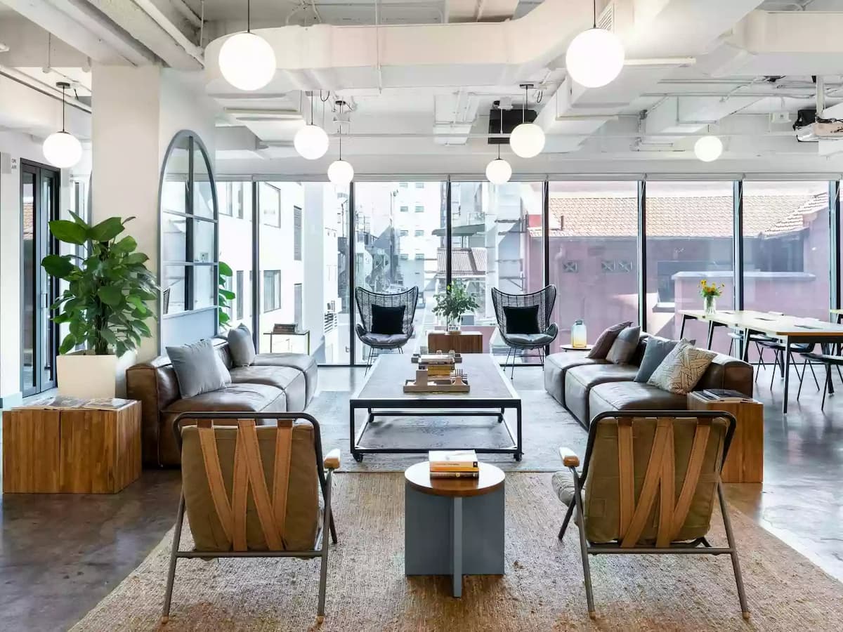 livingroom-style working space with couches, wicker chairs and individual seats