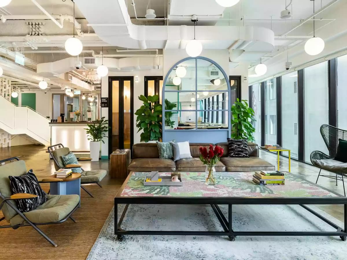 living room style office suite with bulbs, carpet, and industrial decoration