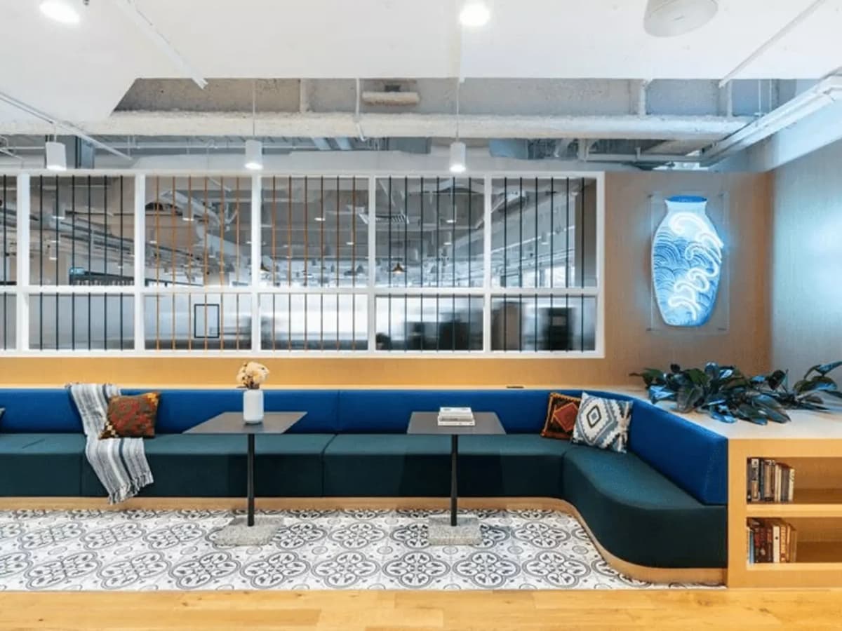 l-shaped couch with tables and common working space