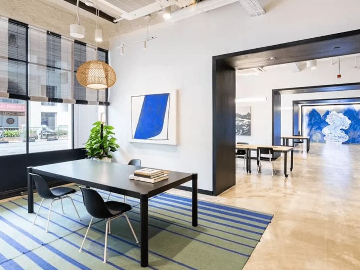 meeting rooms in long hallway with hues of blue