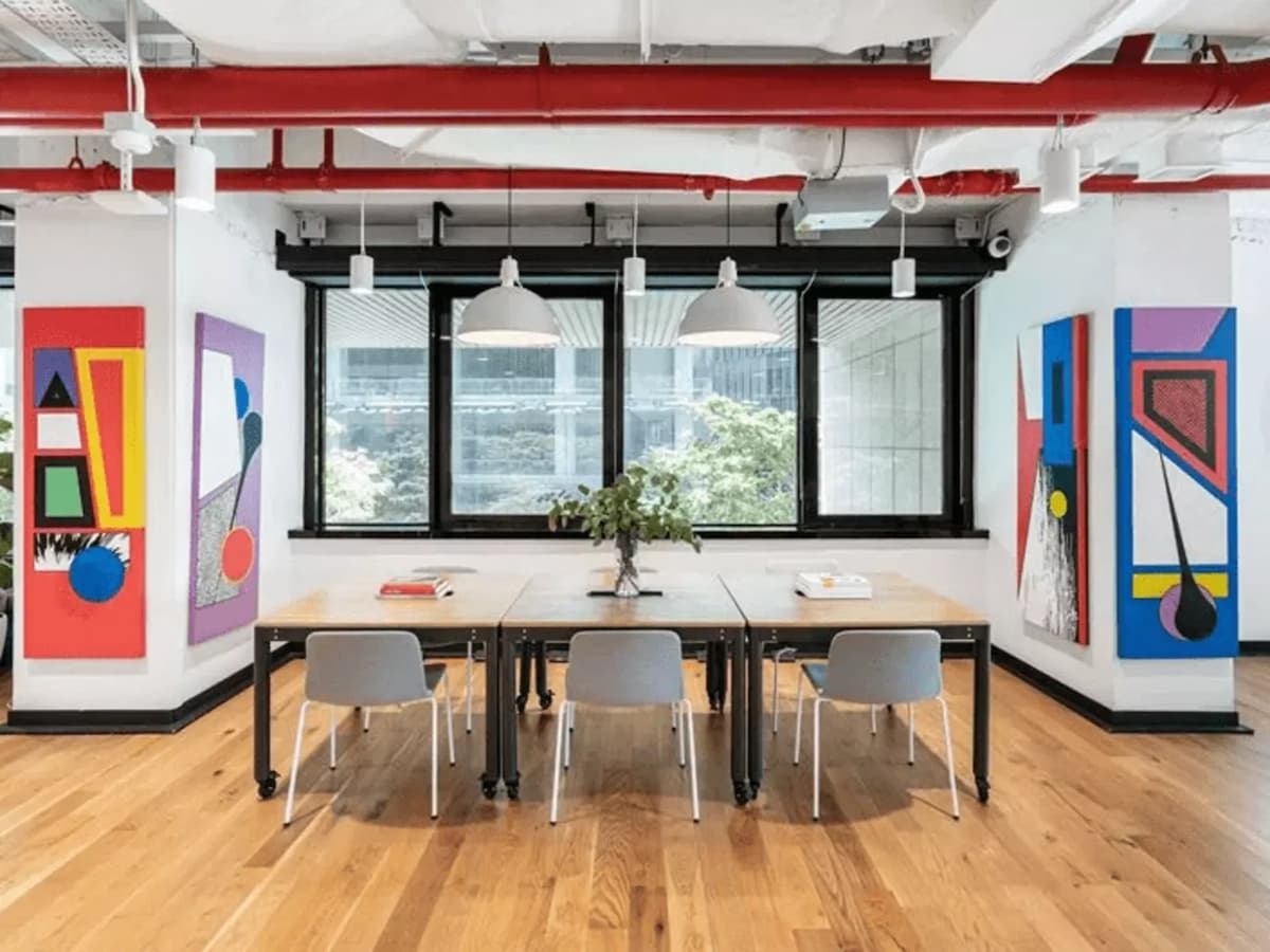 six chairs with tree in the middle of table in coworking space