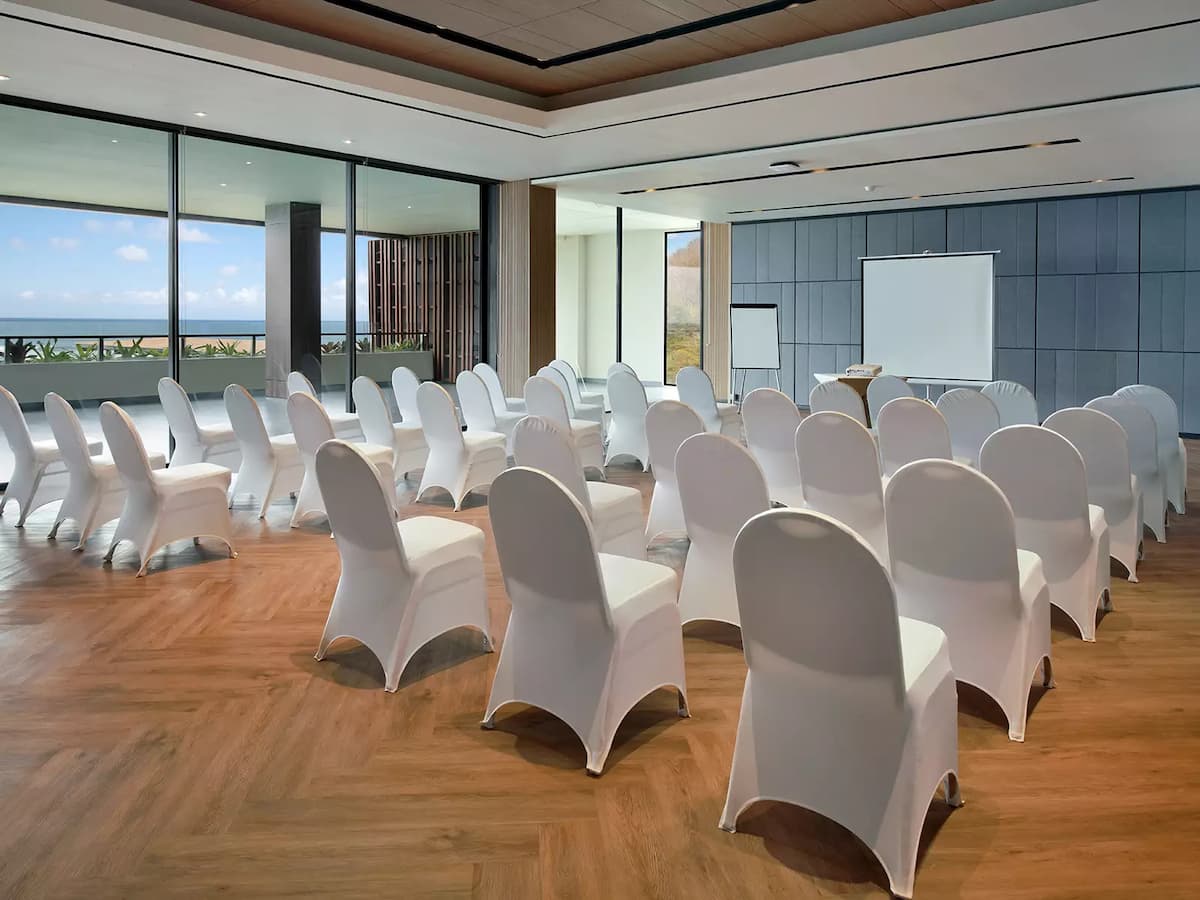 a private room full of white chairs for seminar