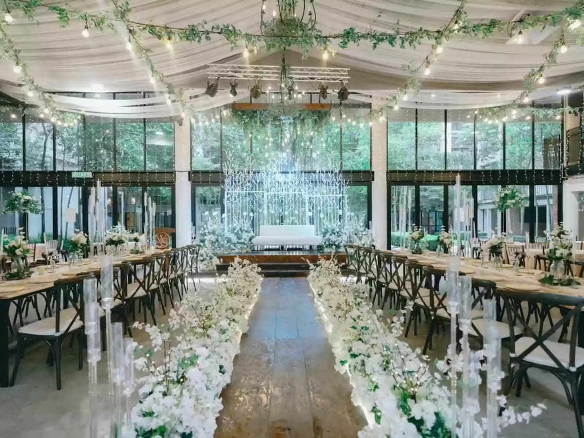 glass wedding venue dominated with white flowers