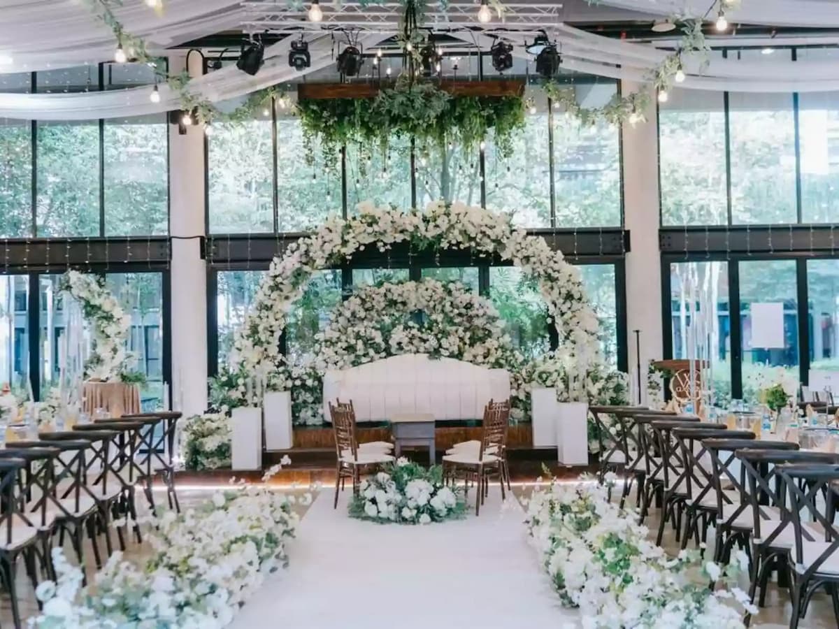 wedding stage and aisle surrounded with white decorations