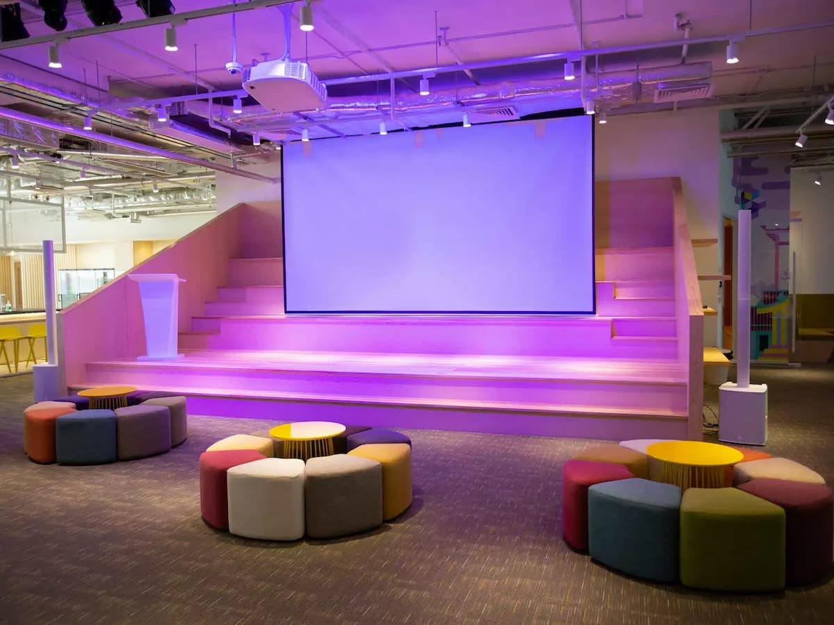 a wide room with soft chairs and paper screen