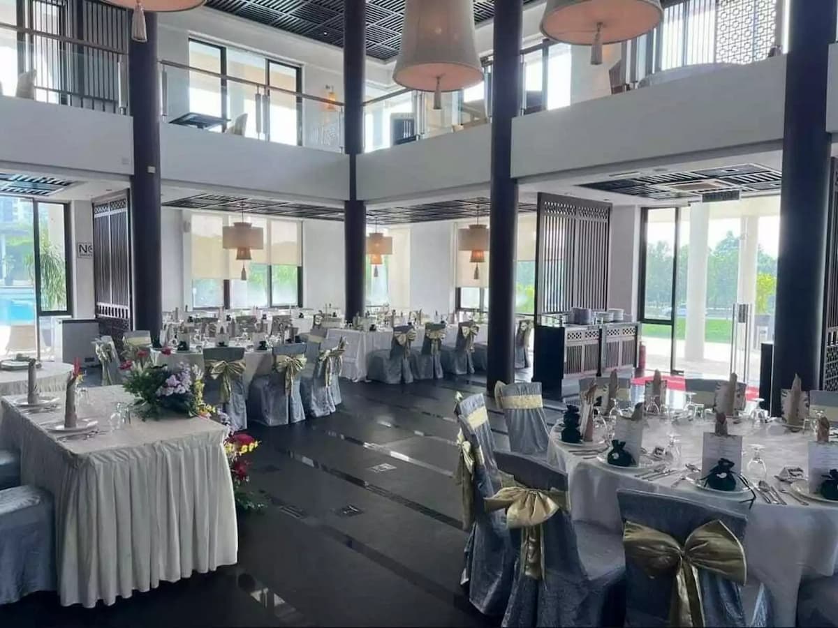 indoor wedding venue with round table setup and high ceiling
