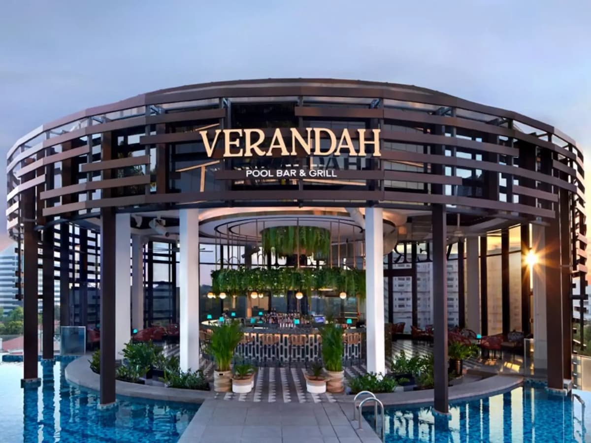 a veranda pool bar and grill with pool around it