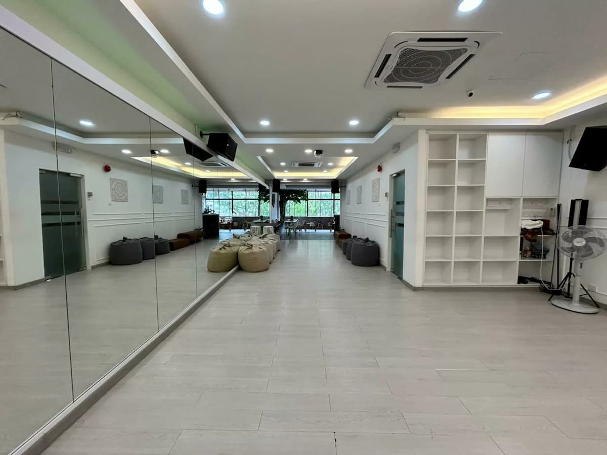 a room with white paint and full length glass mirrors