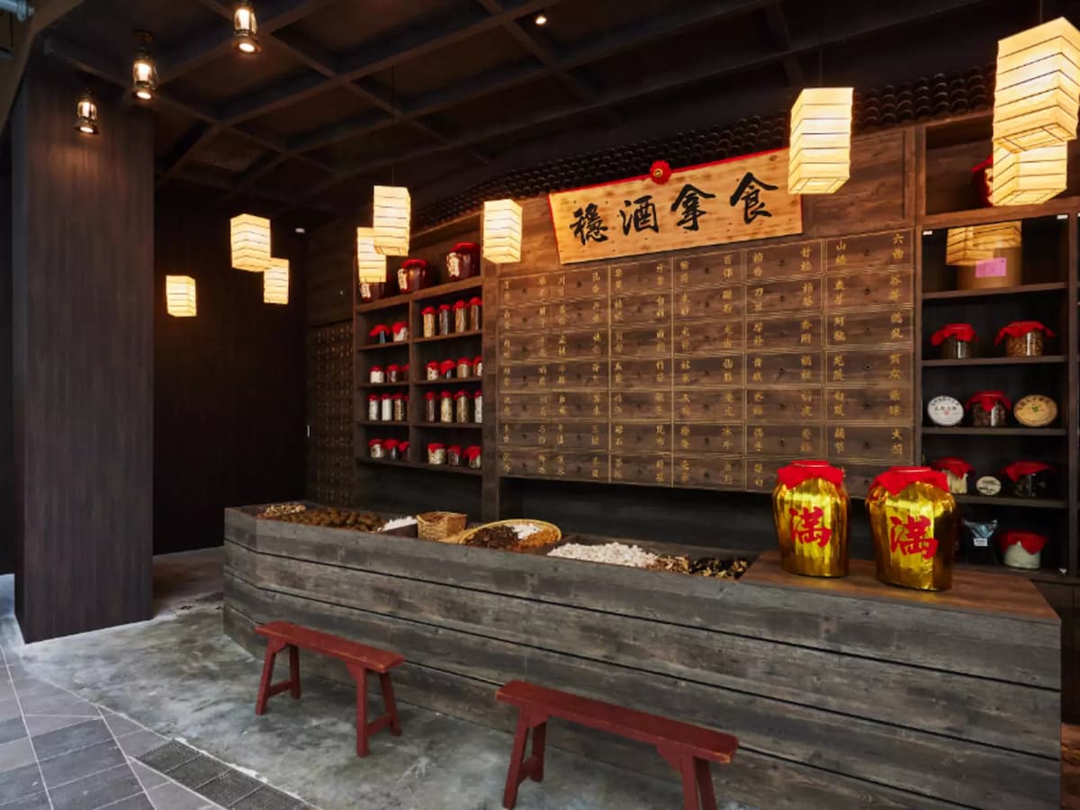 traditional decor with wooden storage shelves, large jars, and hanging lanterns