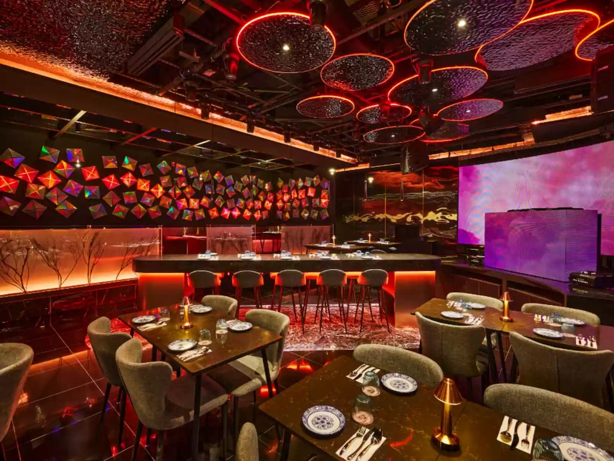 modern dining area with geometric wall art and vibrant lighting