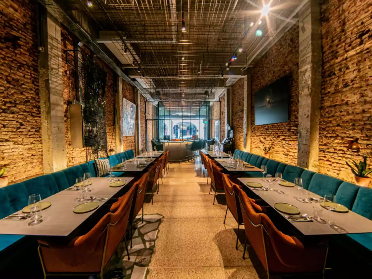 modern dining setup with long tables and chic decor at tempt event space in singapore