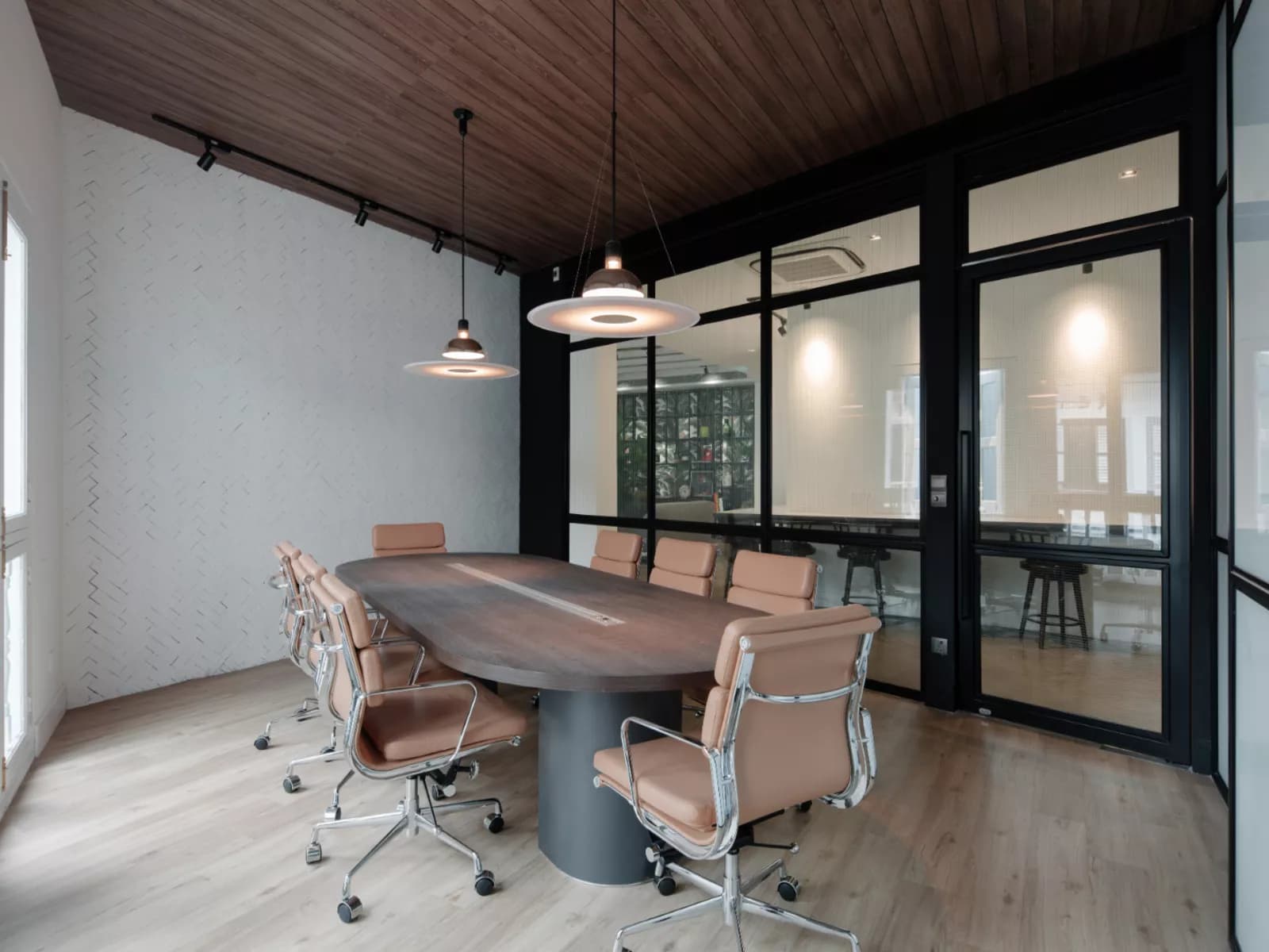 modern conference room featuring a long wooden table, beige swivel chairs, wooden ceiling, and glass walls