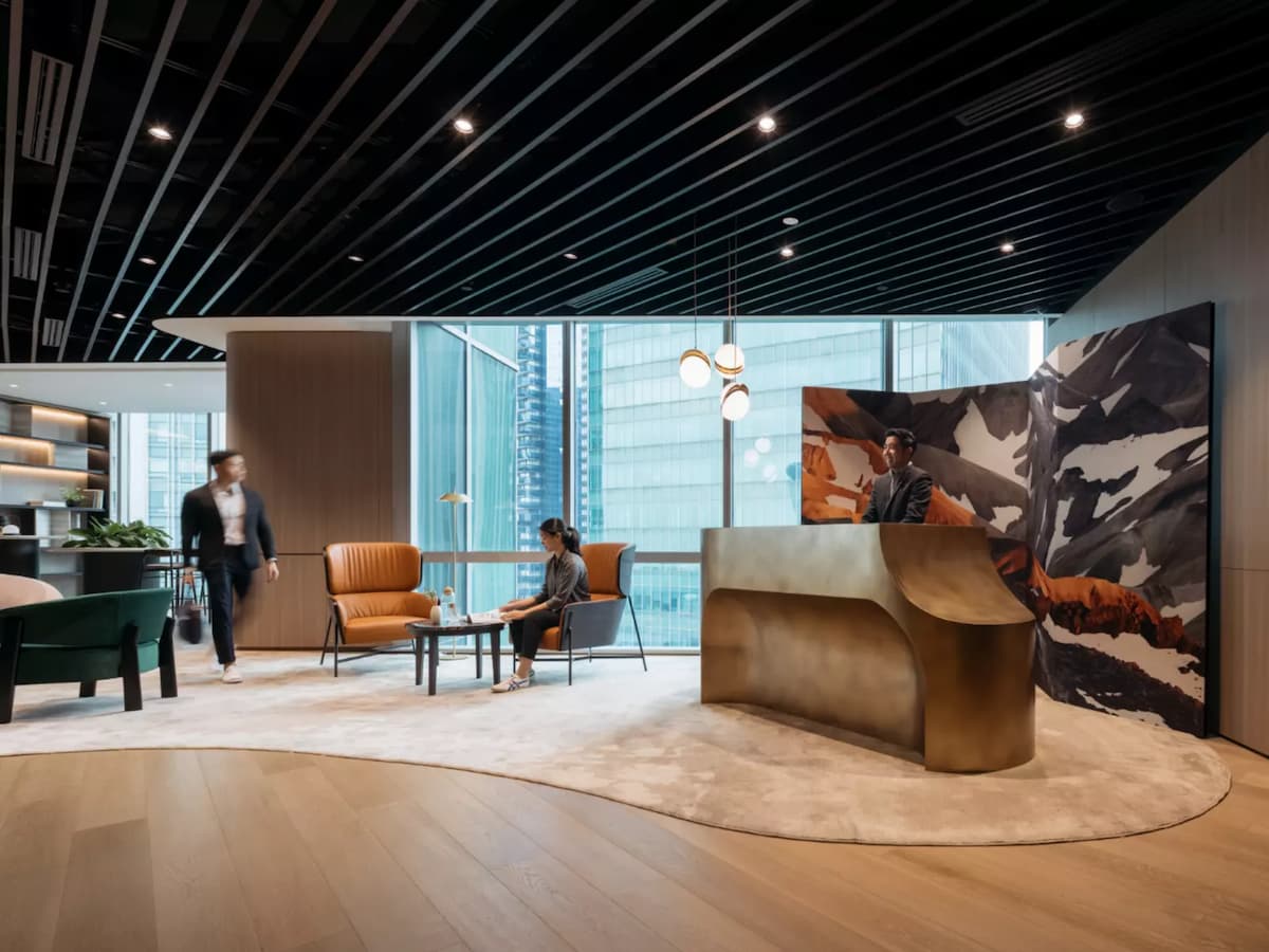 a stylish lobby with a modern reception desk made of sleek materials, complemented by contemporary lighting fixtures