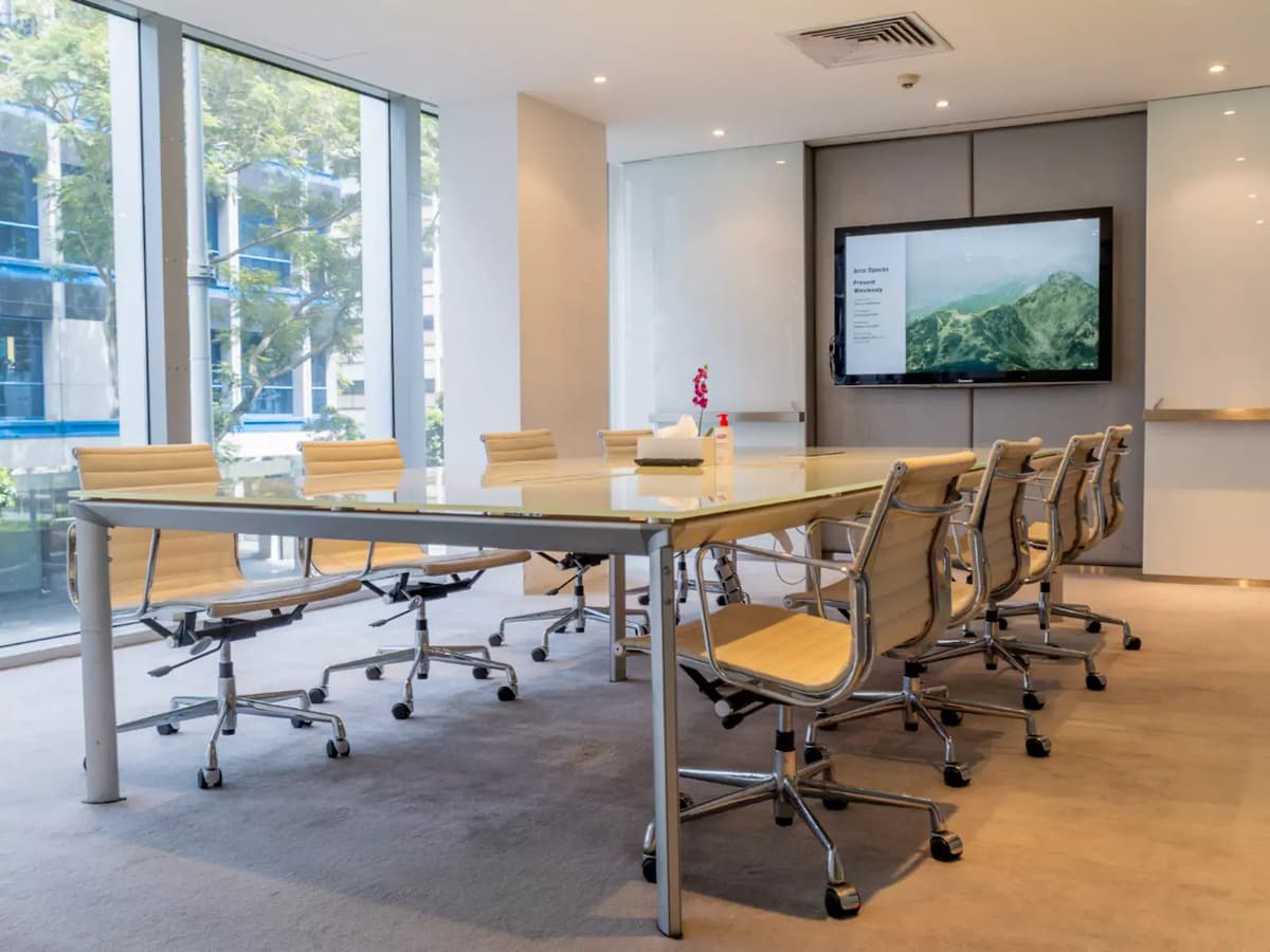 clean and modern meeting room with a glass table and ergonomic chairs