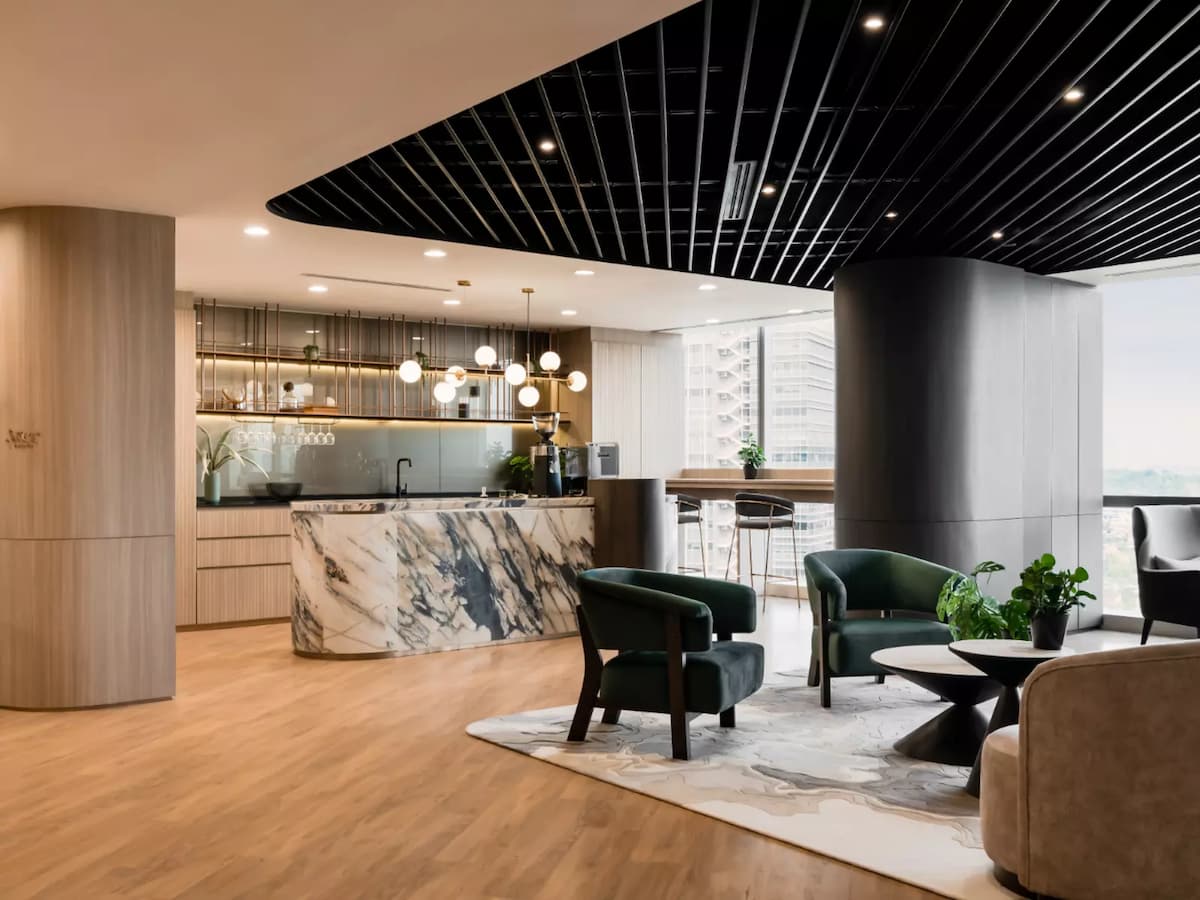 marble pantry counter with pendant lights next to lounge seating at private event space in kuala lumpur