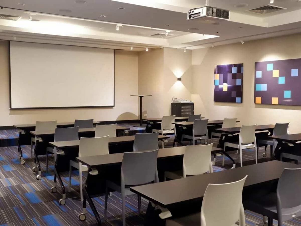 conference hall with rows of tables and chairs