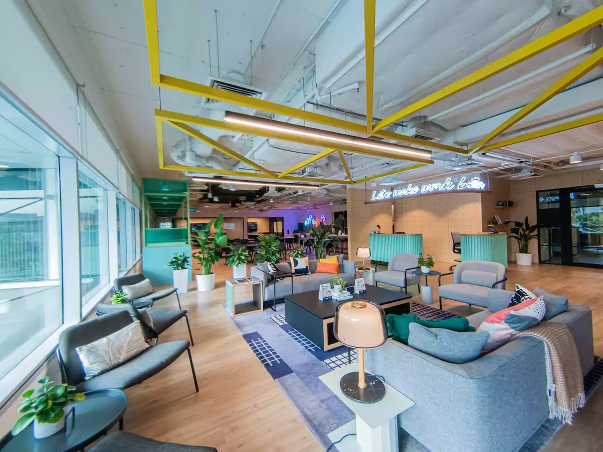 a spacious and modern space with comfortable seating areas and a bright and colorful design