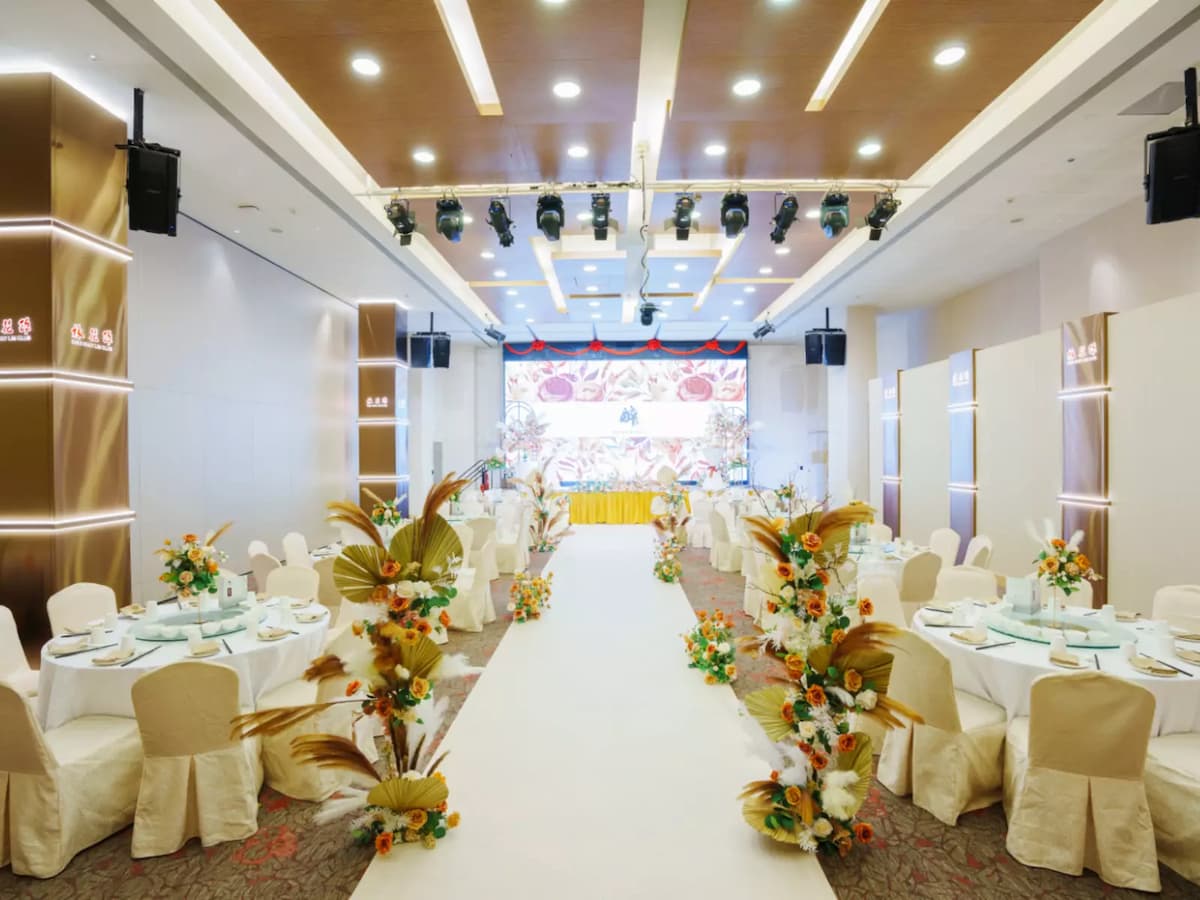 stunning wedding banquet hall featuring a beautifully decorated white aisle lined with floral arrangements