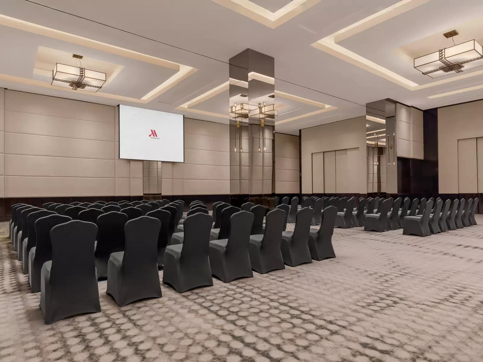 rows of black chairs facing a screen