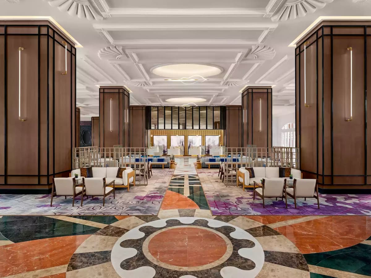 a luxurious hotel lobby with various seating on intricate geometric patterns floor