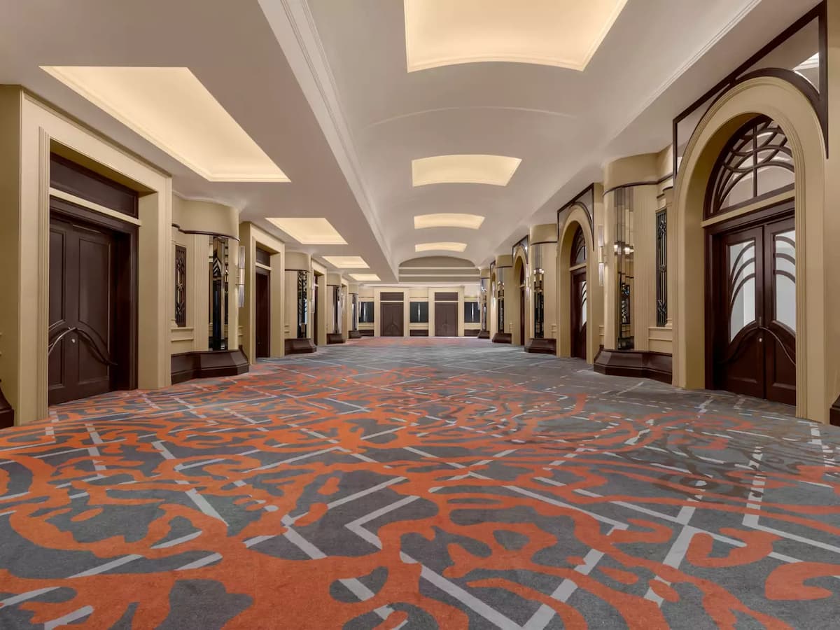 an elegant hallway with pattern carpet