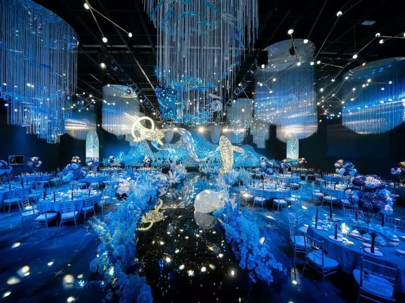 An extraordinary underwater-themed event venue featuring shimmering blue lighting