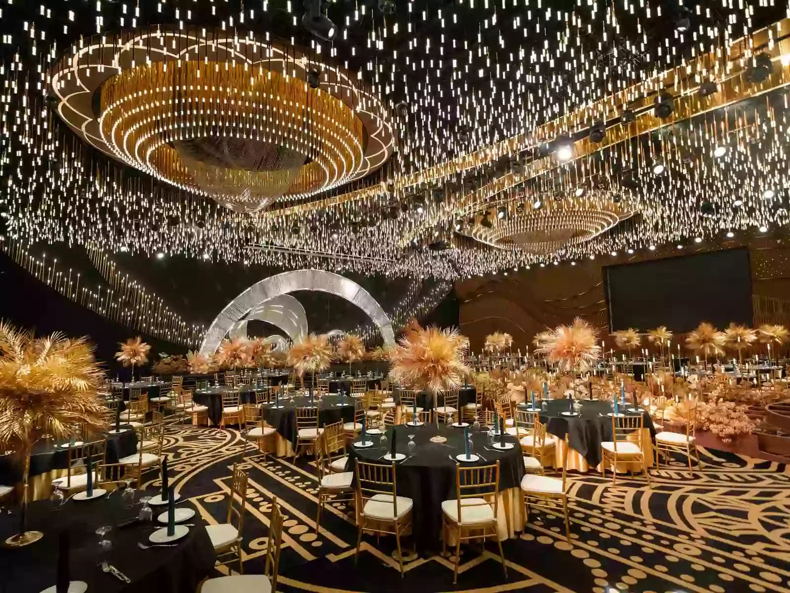 A lavish banquet hall with a dramatic black-and-gold color scheme