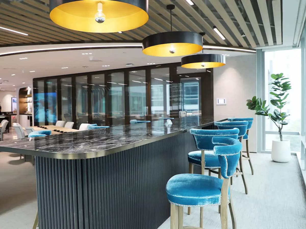 Modern bar lounge area with high seating and contemporary lighting.