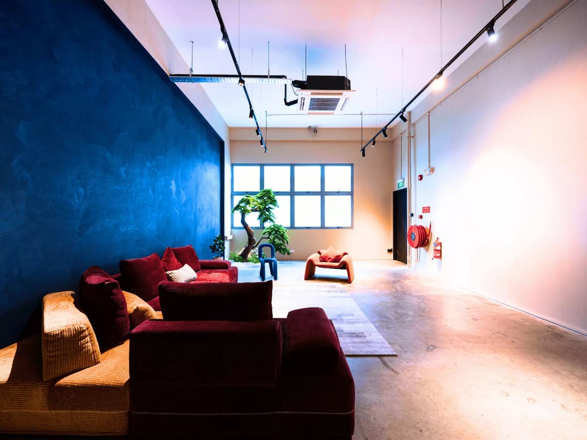 Spacious event area with colorful seating, blue feature wall, and large windows