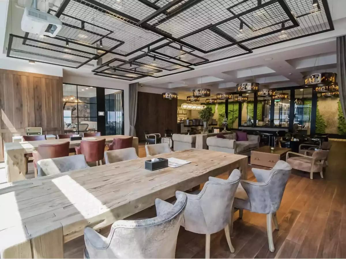 Modern lounge-style event space with communal tables and comfortable seating.