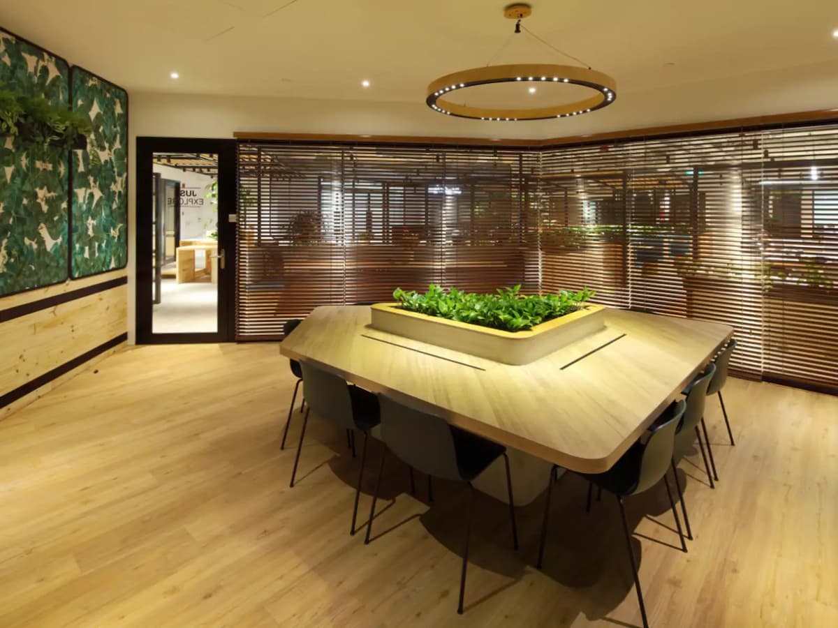 Modern meeting space with communal table and warm wood interior design.