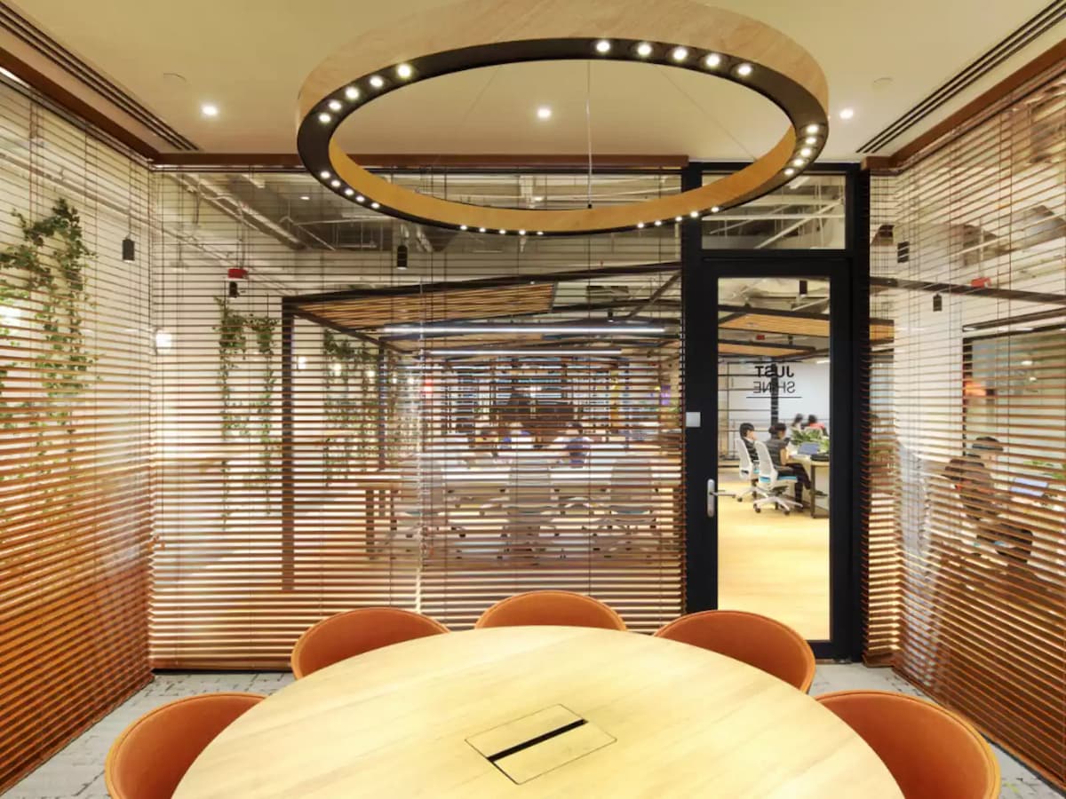 Modern meeting room with circular lighting and glass partition walls.