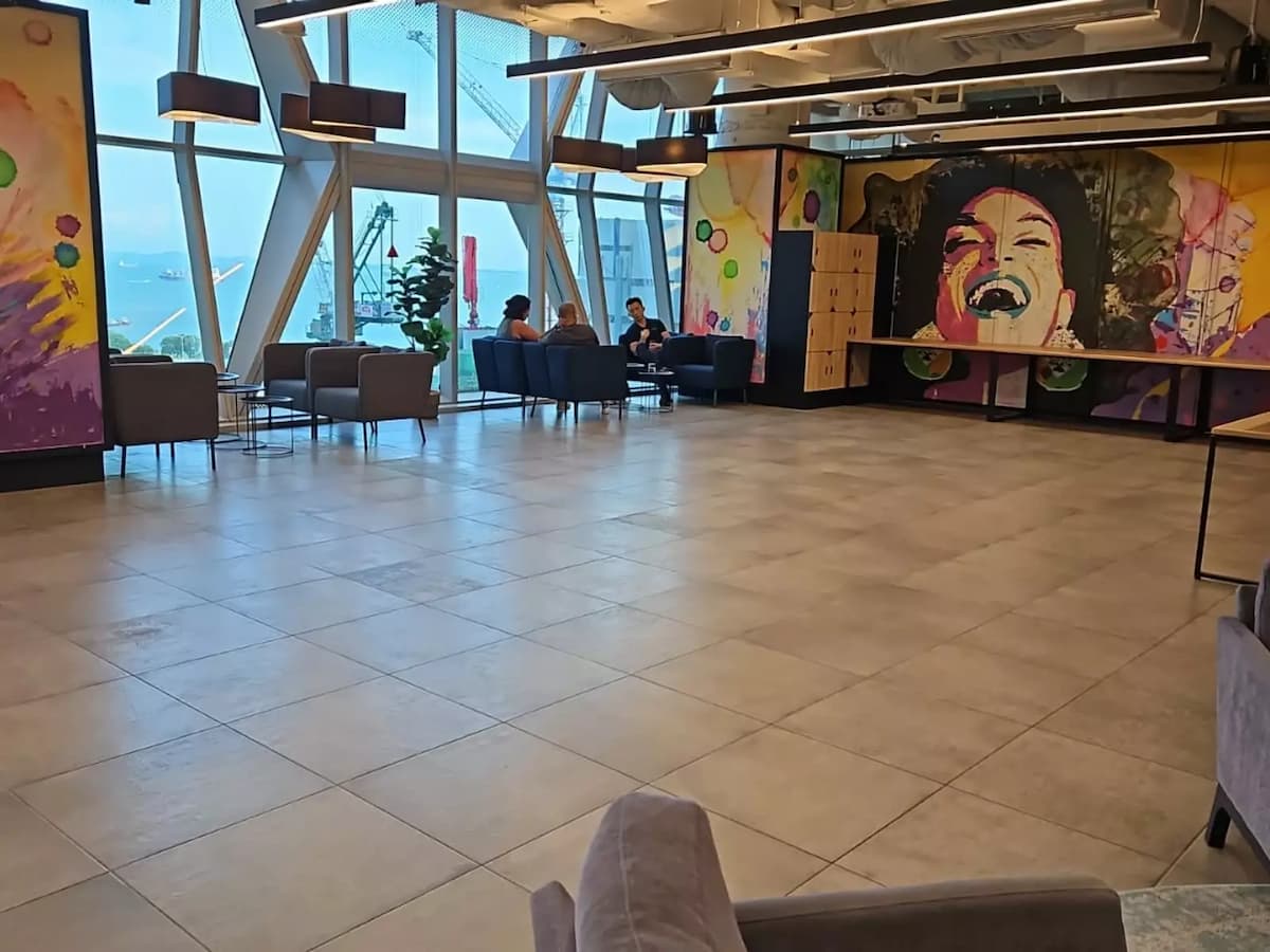 Modern lounge space with colorful mural art and floor-to-ceiling windows.