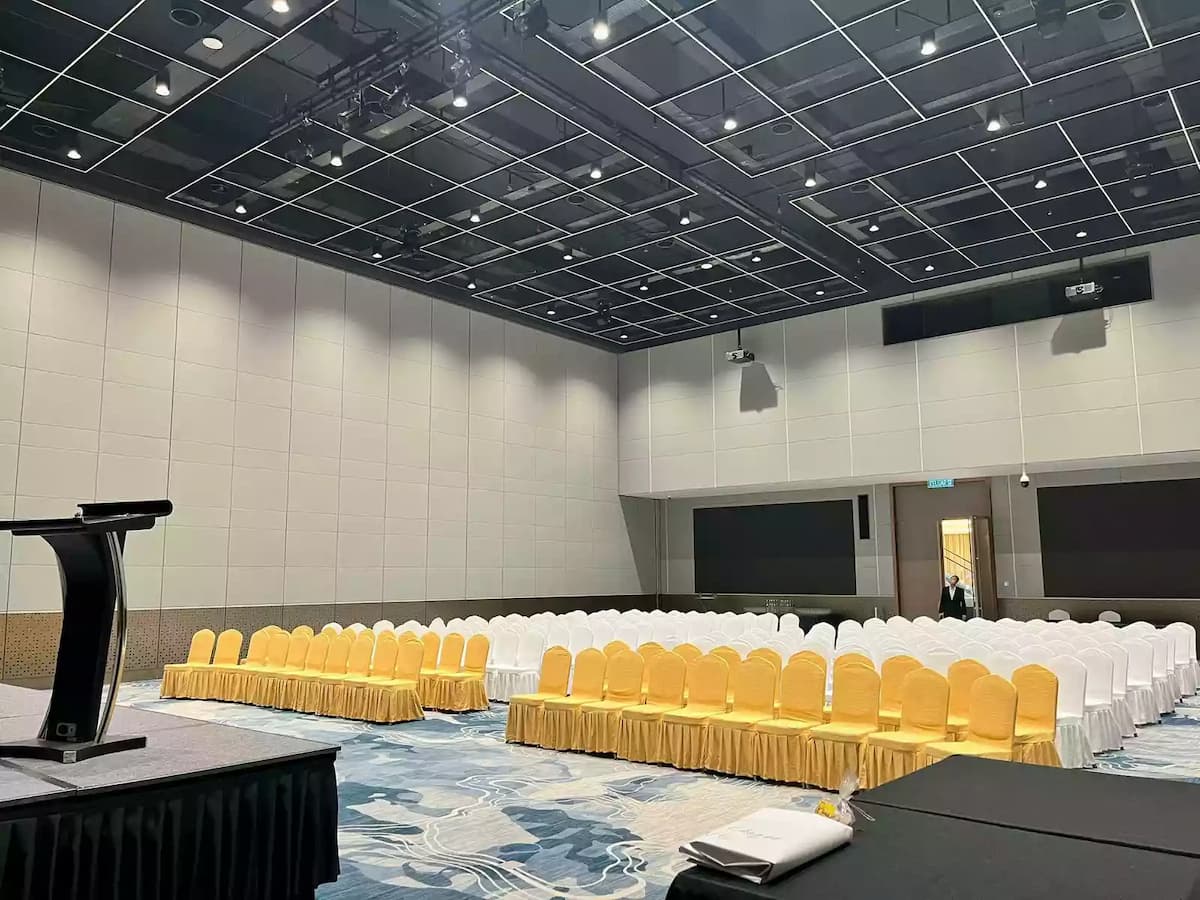 row of yellow chairs and white chairs facing a podium