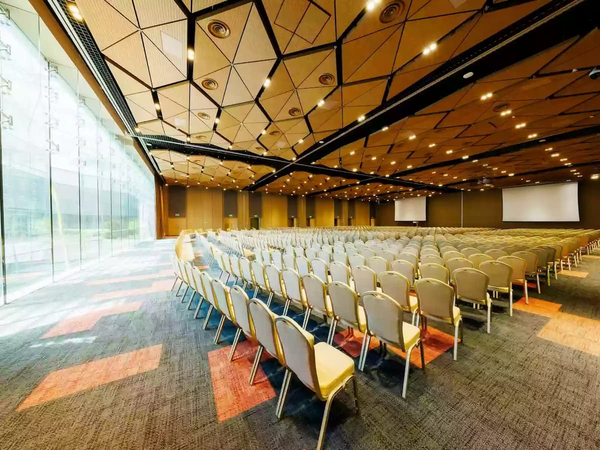 Large conference hall with theatre-style seating and presentation screens.
