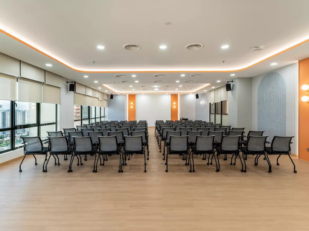 row of black chairs in theatre setup