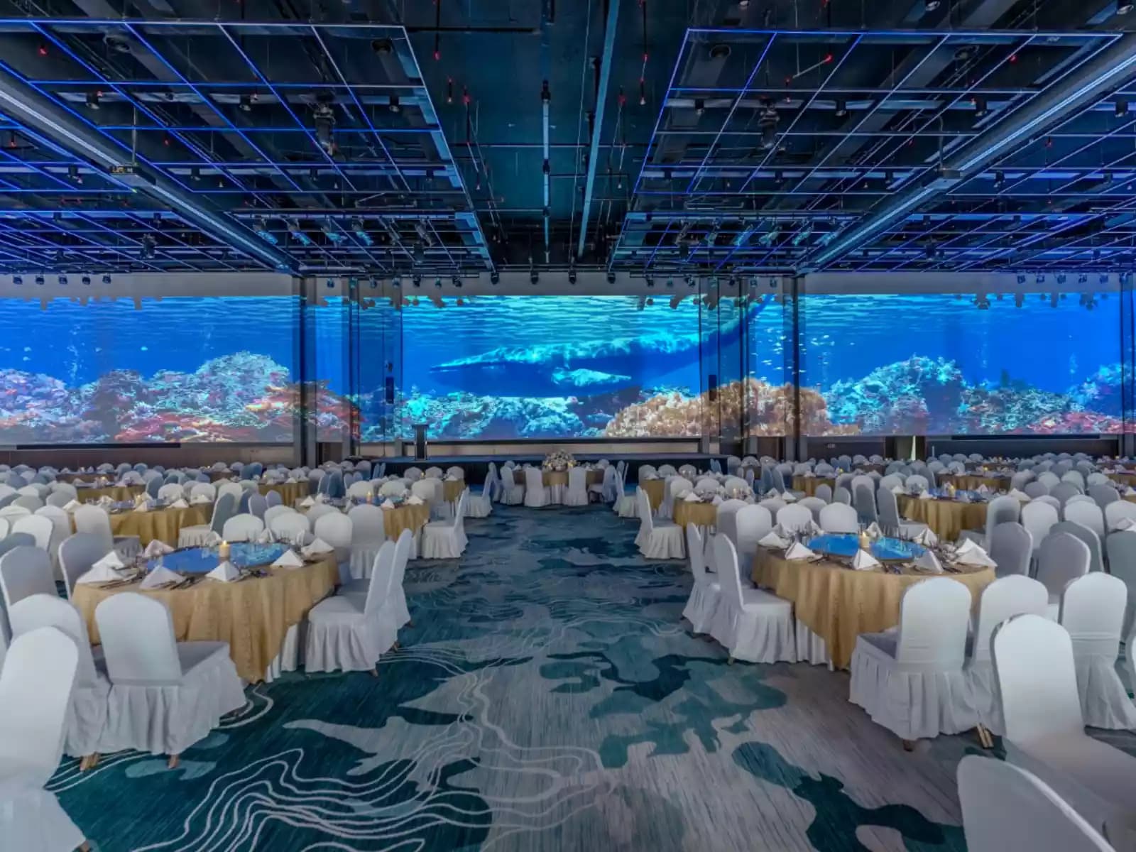 Grand ballroom with immersive ocean-themed LED walls, banquet seating, and a spacious event layout, ideal for gala dinners, corporate conferences, award ceremonies, weddings, and large-scale celebrations.