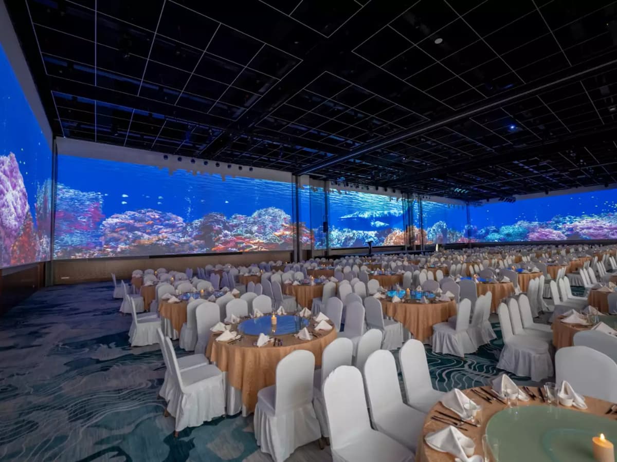 Spacious ballroom with immersive LED walls, elegant banquet seating, and panoramic digital displays, ideal for gala dinners, corporate conferences, award ceremonies, weddings, and large-scale events.