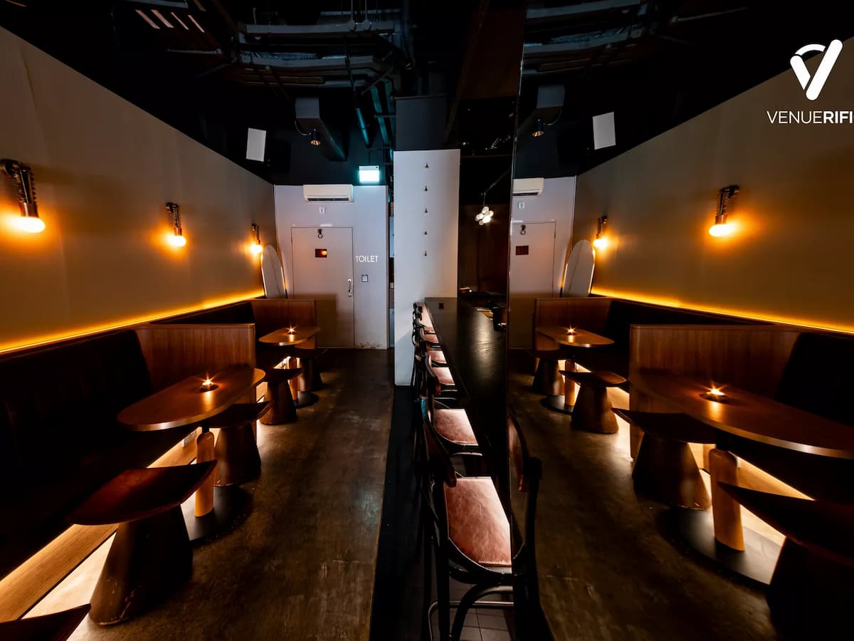 cocktail bar with cozy booth seating and warm ambient lighting.
