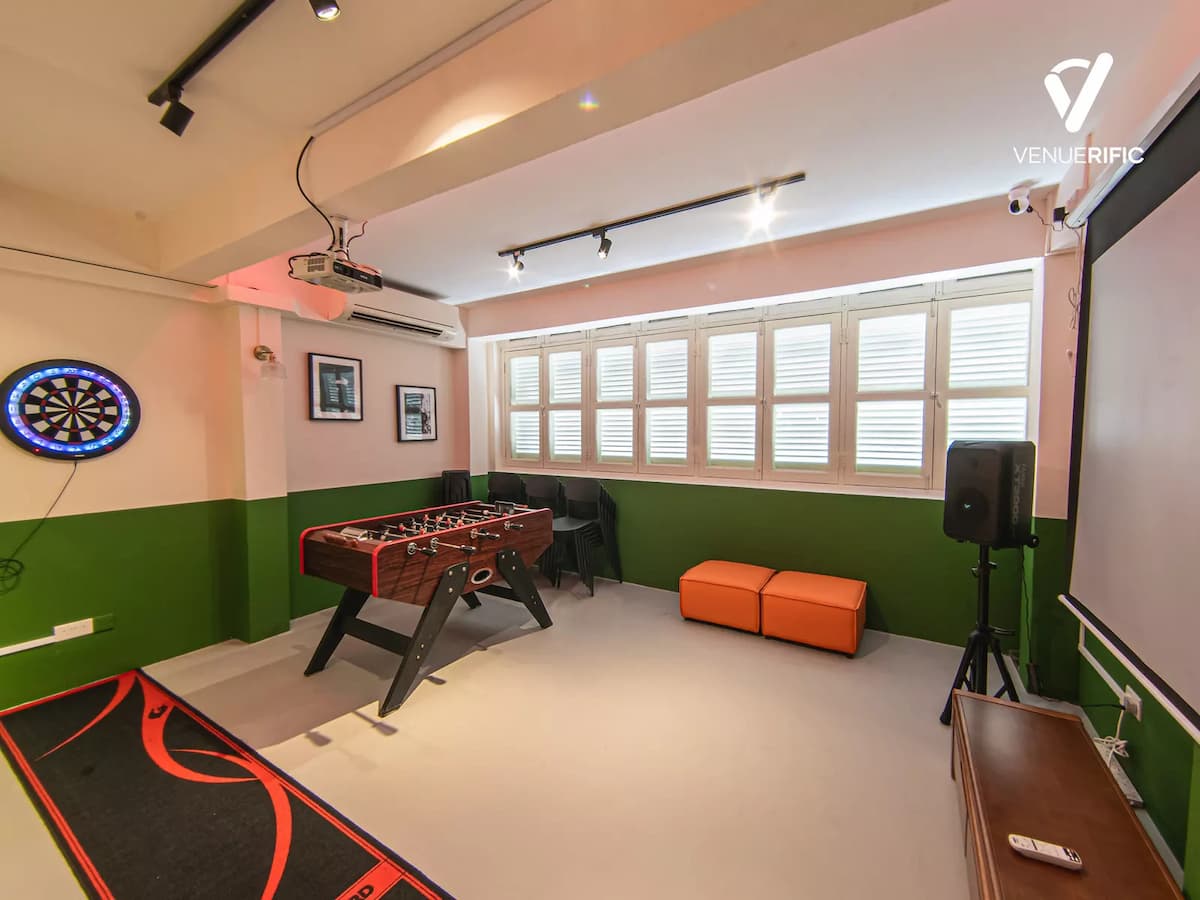 event space with foosball table, dartboard and projector screen