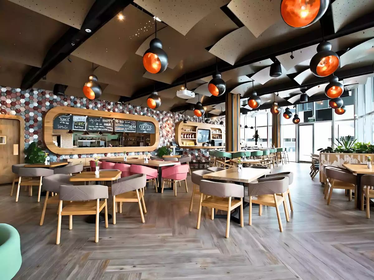 Spacious modern café with stylish seating and warm ambient lighting.