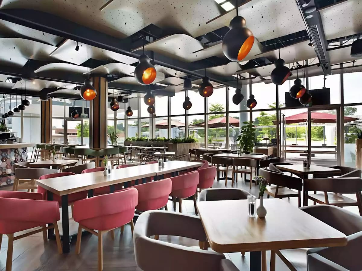 Bright modern café with large windows and stylish dining seating.