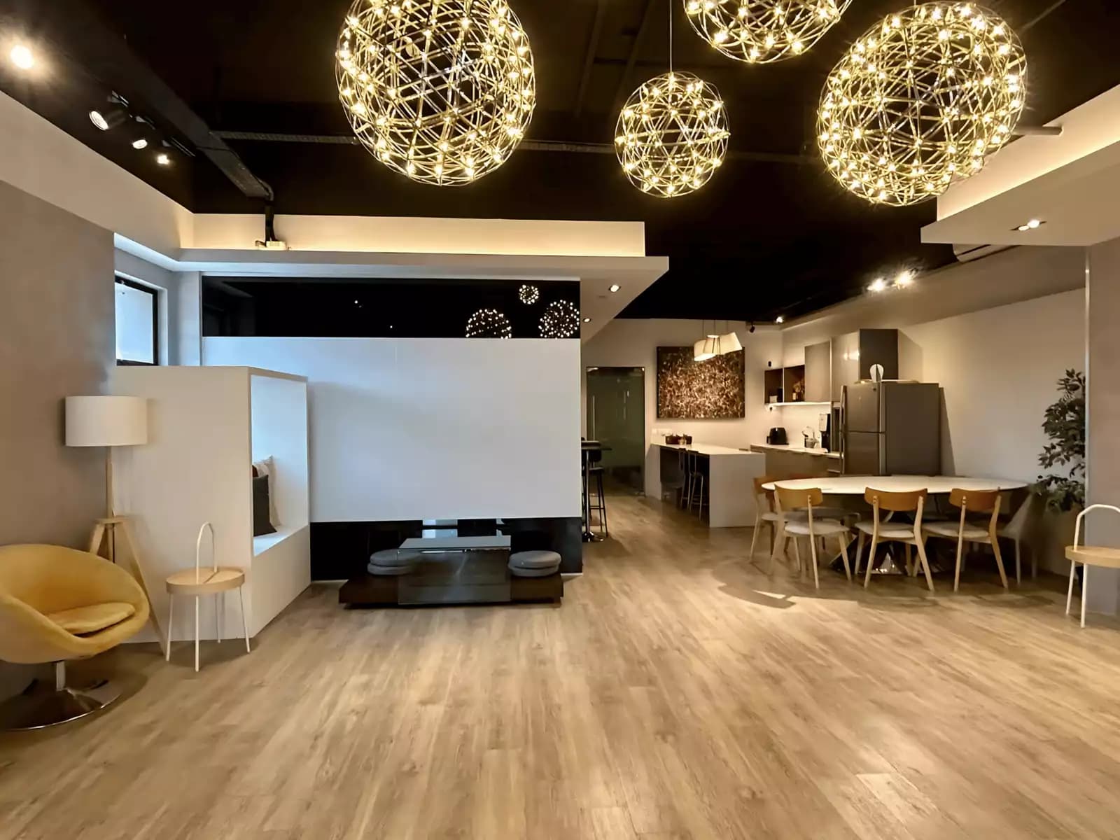 Spacious modern venue with elegant lighting and dining area.