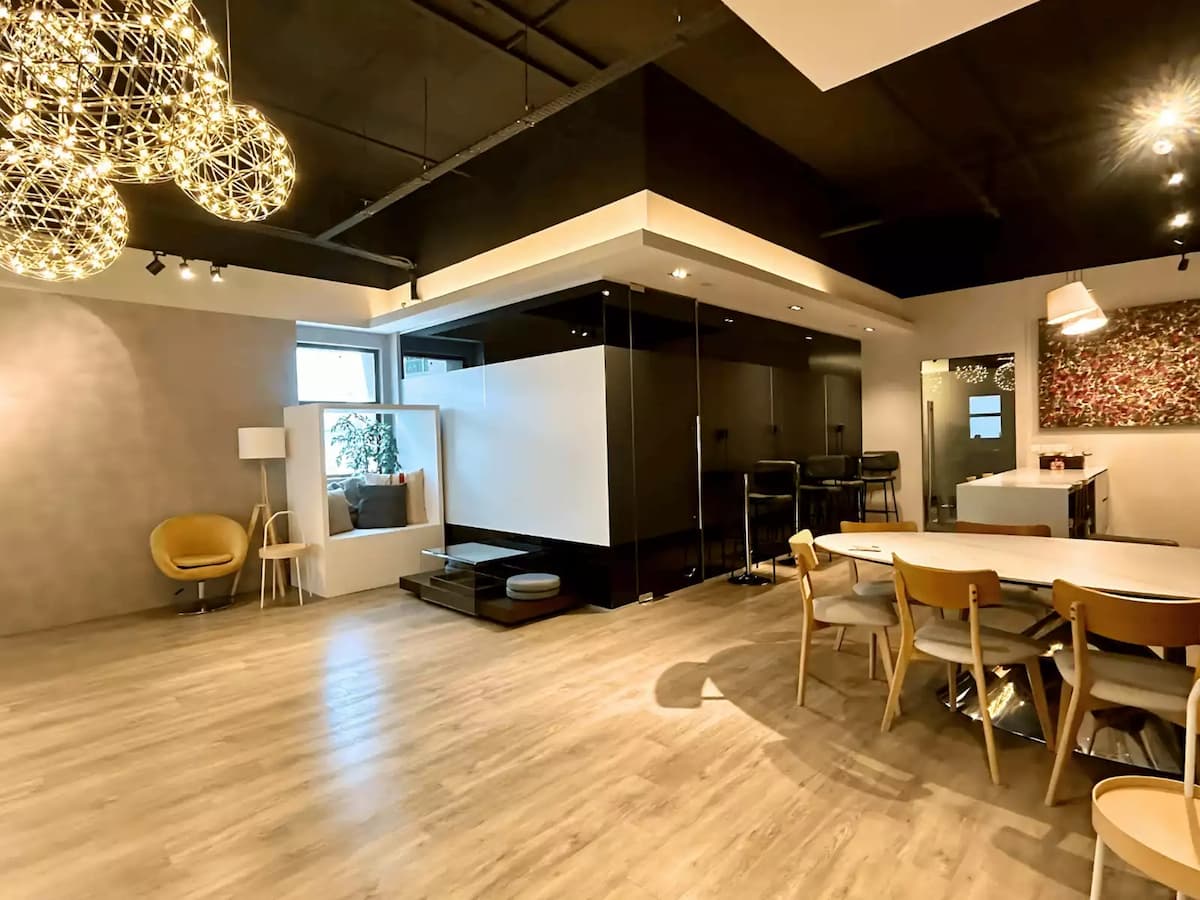 Modern event space with elegant lighting and minimalist dining setup.